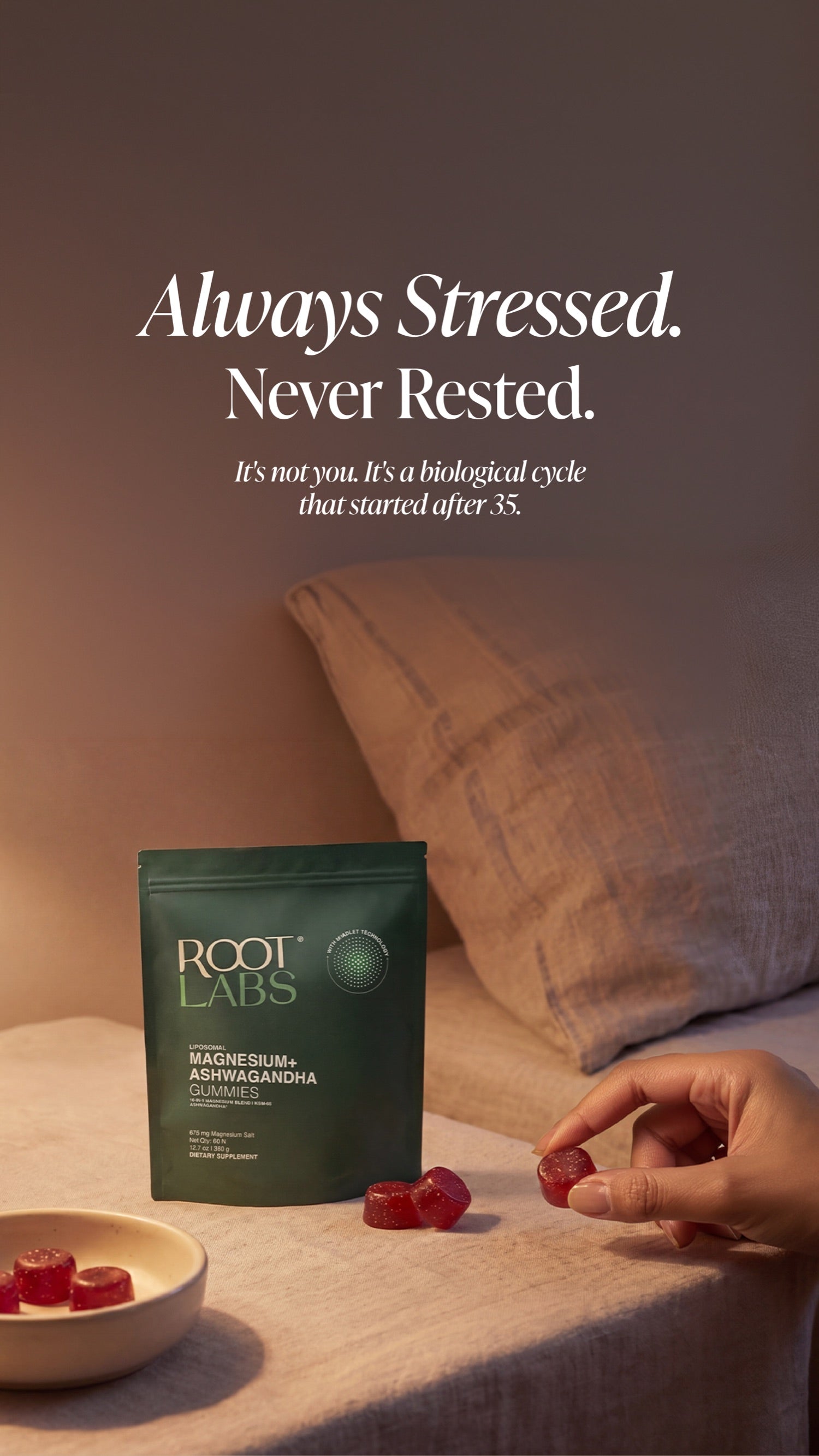 Bedside scene at night: hand reaching for a Root Labs MagAshwa gummy with the pouch and a small bowl of extras on warm linen bedding